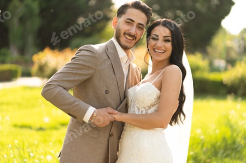 Preview: Bride and groom laughing and holding hands