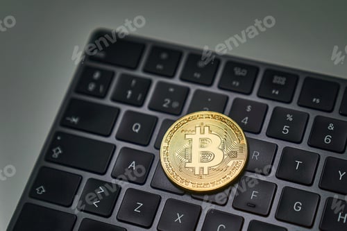 Preview: a bitcoin on a computer keyboard symbolizing financial transactions in cyberspace