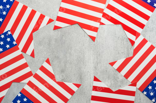 Preview: 4th of July background. USA paper fans, Red, blue, white stars and confetti on gray old concrete wal