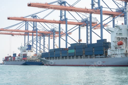 Preview: Big crane loading cargo container from truck to container ship in the international terminal