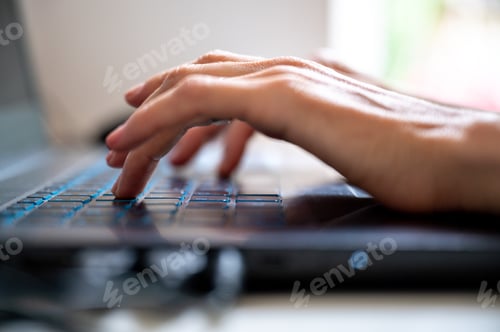 Preview: Typing on laptop computer