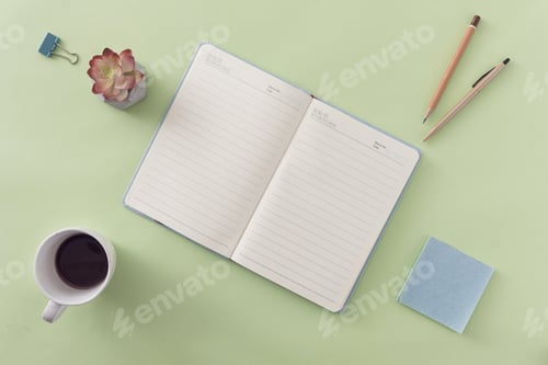 Preview: Business flat lay still life with open journal on green