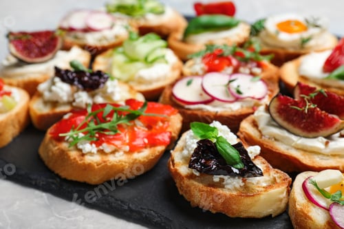 Preview: Different bruschettas on light grey marble table, closeup