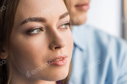 Preview: cropped image of girlfriend and boyfriend looking away