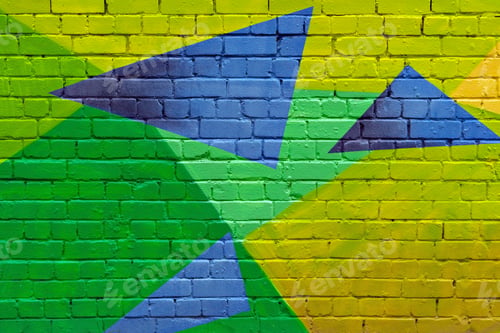 Preview: Vivid geometric street art mural with green, yellow, and blue triangles painted