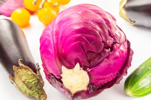 Preview: close-up fresh whole vegetables red cabbage, cucumber, eggplant, cherry tomatoes on white background