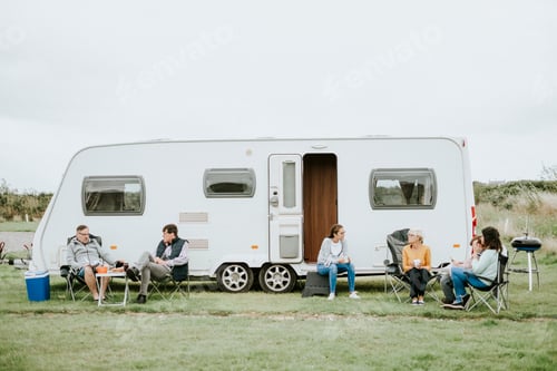 Preview: Group of people sitting outside a trailer park