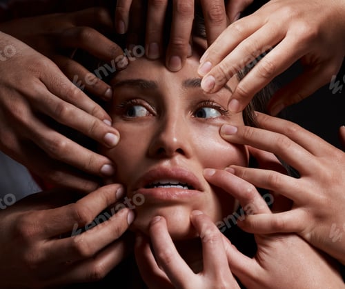 Preview: I feel trapped. Shot of hands grabbing a young womans against a dark background.