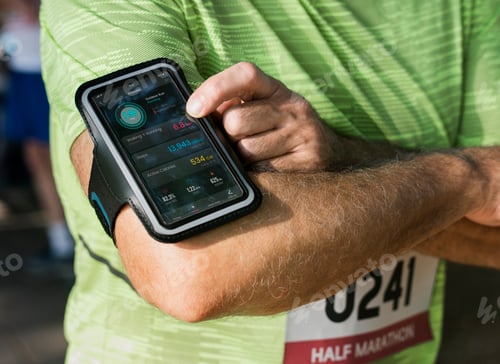 Preview: Senior runner using a fitness tracker application