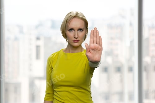 Preview: Serious woman is showing stop gesture.