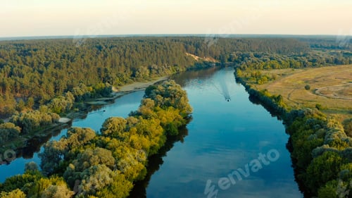 Preview: Aerial view above a beautiful landscape with a river while sunset. Aerial view of summer landscape.