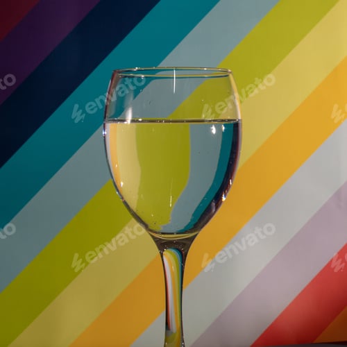 Preview: Closeup shot of a wine glass with water on a colorful background