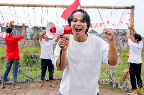 Preview: Energetic Young Men Cheer Loudly With Megaphones During National Holiday Celebrations.
