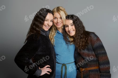 Preview: Happy smiling friends. Three attractive girls in woolen coats.