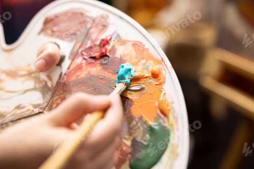 Preview: Artist mixes variety of watercolor paint on palette to create rustic masterpiece