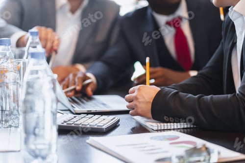 Preview: Business professionals collaborate on project analysis during a meeting in a corporate setting