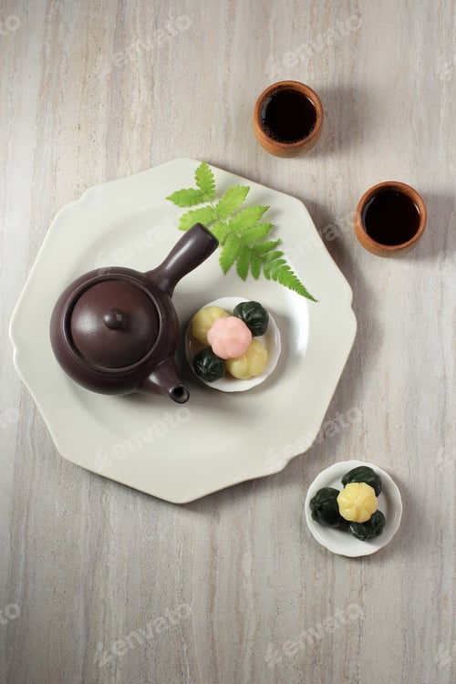 Preview: Colorful Songpyeon Kkultteok (Rice Cake with Honey FIlling) in a Wooden Dish.