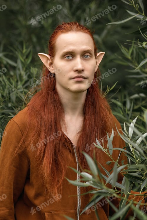 Preview: Artistic elf man with red hair and green eyes in the forest