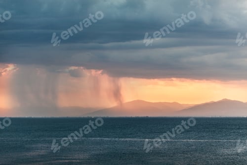 Preview: Rain clouds in distant plains near mountains