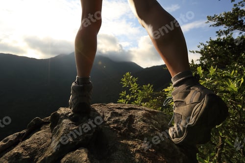 Preview: young hiker legs hiking on mountain peak