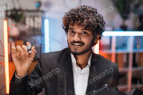 Preview: Focused smart businessman, drawing graphs on glass presentation board