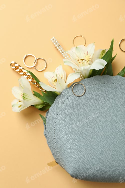 Preview: Cosmetic bag with cosmetics, jewelry and alstroemeria on beige background