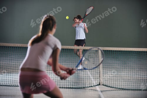 Preview: Young Girls Playing Tennis Game Indoori In Tennis Court