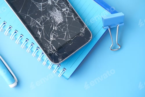 Preview: Top view of broken smart phone on color background