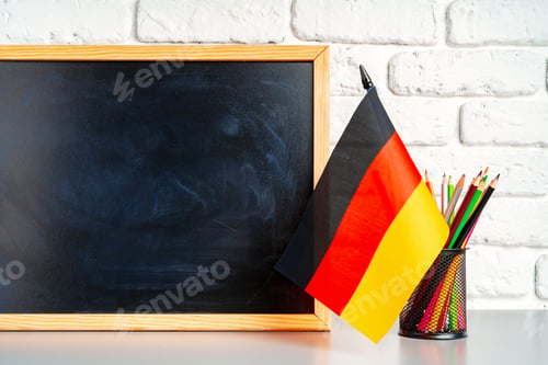 Preview: Blackboard and German flag on school desk
