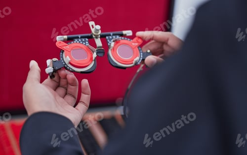 Preview: Glasses, lens and trail frame with ophthalmologist tools, vision test with woman hands, healthcare