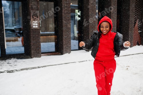 Preview: African american woman in red hoodie enjoy winter day.