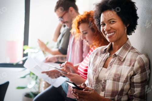 Preview: Happy african american female leader holding negotiations meeting with friendly diverse colleague