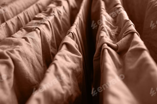 Preview: Close up view of beige folded fabric with textured layers and soft creases