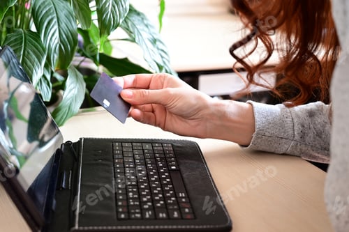 Preview: Online Banking with Red Haired Woman and Tablet