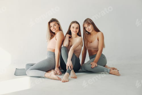 A beautiful girls is engaged in a yoga studio
