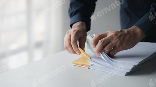 Preview: Businessman sorting stacks of department meeting papers, document management in corporate office. Of