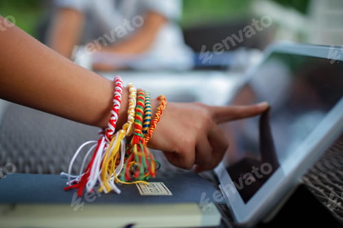 Preview: Hand with handmade bracelets touches laptop, digital small business, e-commerce. Remote job