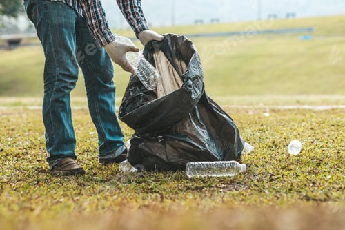 Preview: A man is picking up trash in a park, not throwing trash in the trash can ruin the beauty.