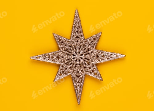 Preview: Christmas star decor on yellow colored background.