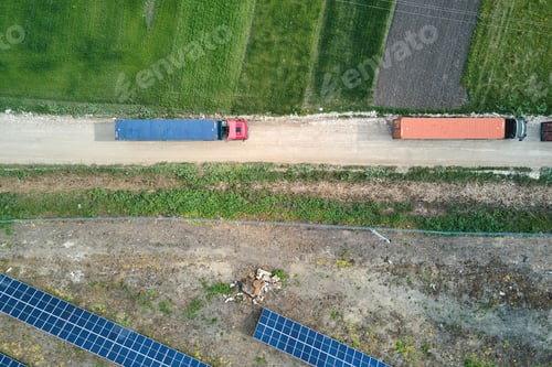 Preview: Aerial view of electrical power plant under construction with truck delivering assembly