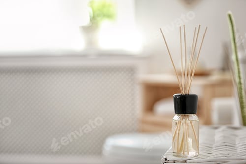 Preview: Aromatic reed air freshener on table against blurred background