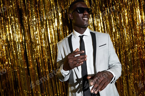 Preview: Stylish black man in sunglasses dancing during party