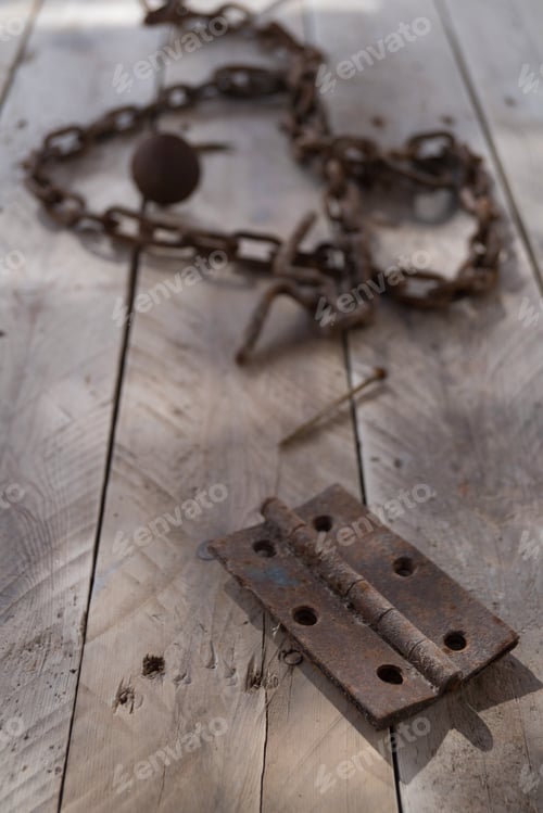 Preview: Vertical shot of rusty antique objects on a wooden surface