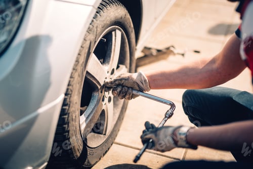 Preview: Tire maintenance, damaged car tyre or changing seasonal tires using wrench
