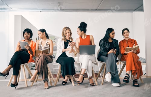 Preview: Shot of a group of businesswomen sitting in a row in an office at work