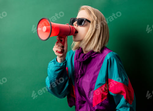 Preview: woman in 90s style punk jacket with loudspeaker on green background
