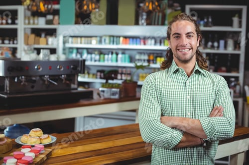 Preview: Espresso machine steaming beside colorful pastries on wooden counter under warm pendant lighting