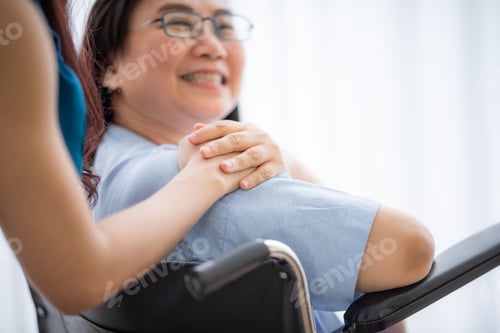 Preview: Woman in Wheelchair with Comforting Young Adult
