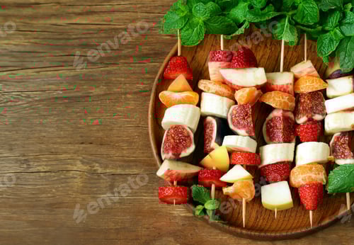 Preview: Colorful Fruit Skewers on Wooden Plate with Mint