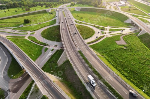 Preview: Cars moving on transport road junction in city, aerial view